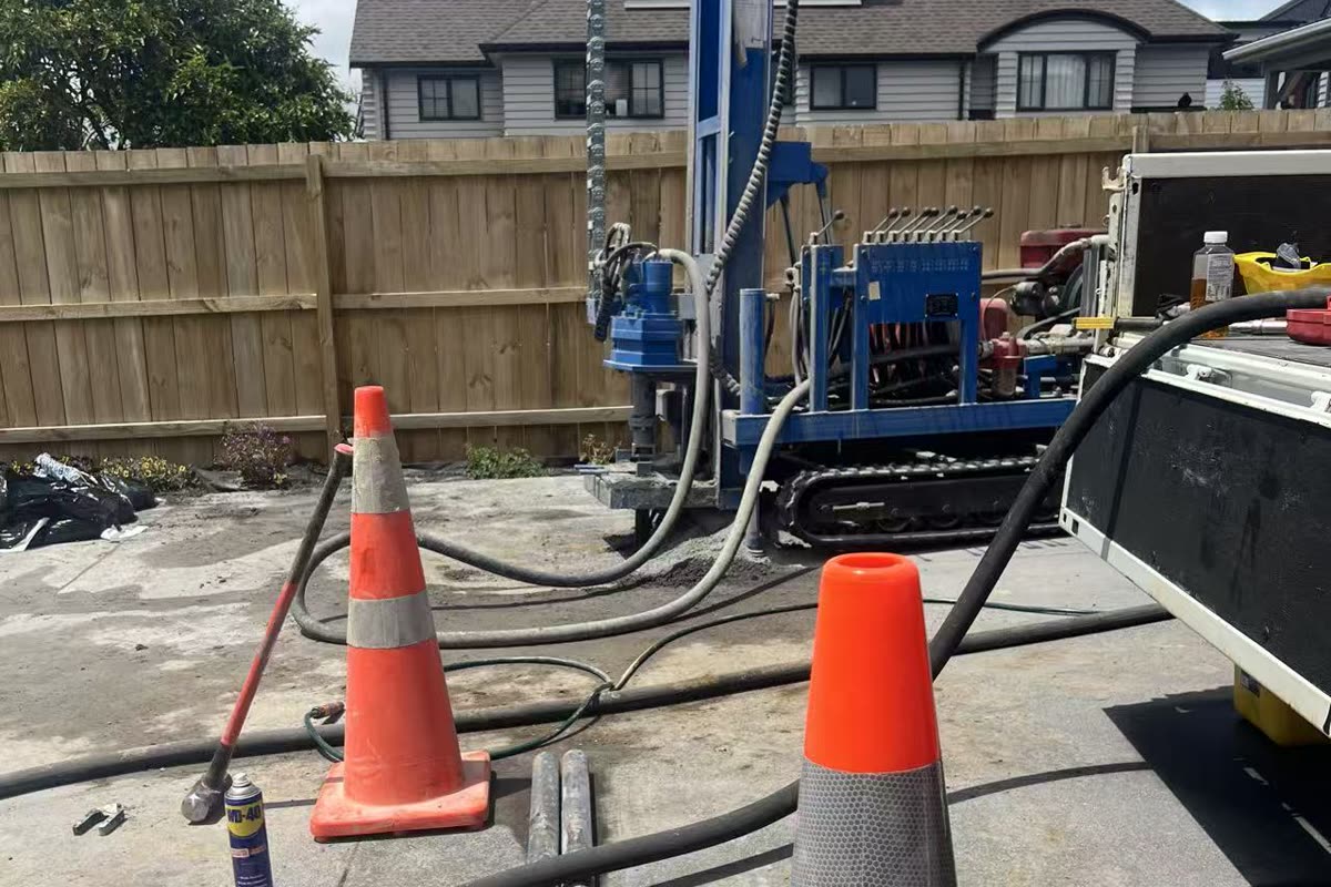 Percussion drilling rig operating on site