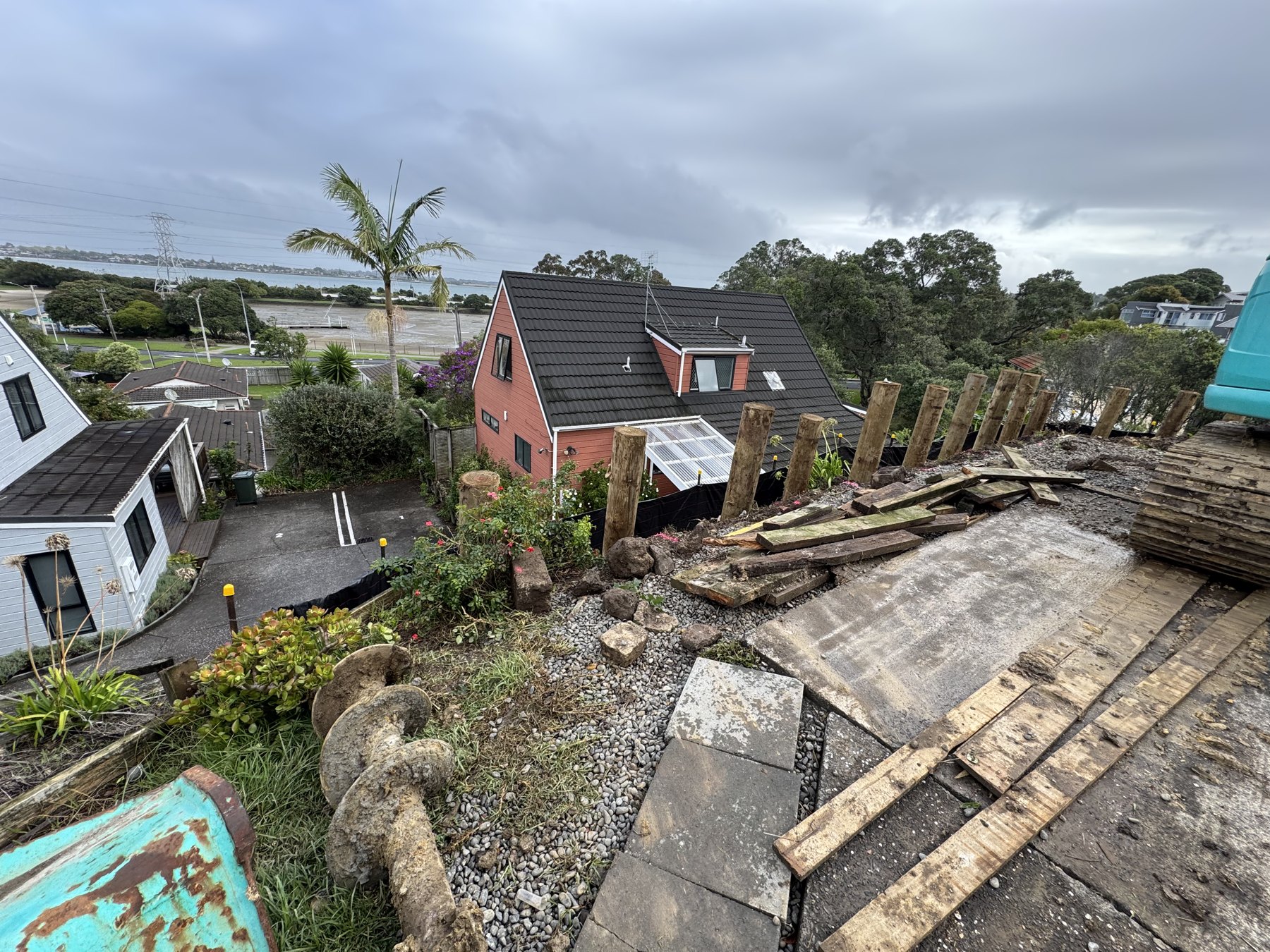 Retaining wall excavation and timber poles at Quadrant Road, Onehunga